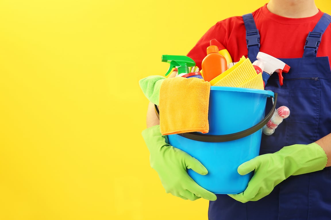 Cleaner Holding Bucket of Cleaning Materials 