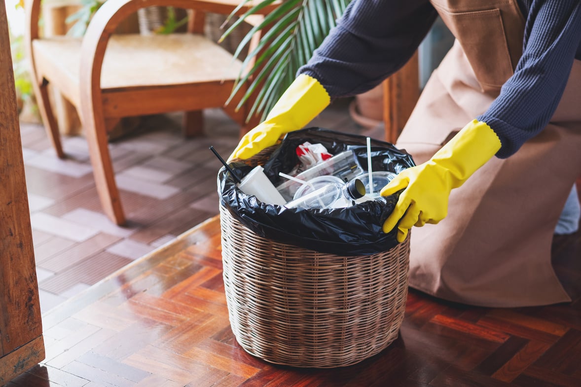 A Woman Cleaning and Taking Garbage Bag Out of the Trash Bin at